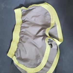 Size small Grey althetic shorts with yellow accents. No outside damage